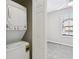 A stacked washer and dryer next to a doorway that leads to a bedroom at 2718 Bushman Dr, Kissimmee, FL 34746