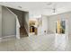 Open-concept living room with stairs, tile floor, and view of patio at 2718 Bushman Dr, Kissimmee, FL 34746