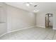 Bright living room with tiled flooring, ceiling fan, and neutral paint at 2718 Bushman Dr, Kissimmee, FL 34746