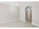 Bright living room with neutral paint, archway, and tiled flooring at 2718 Bushman Dr, Kissimmee, FL 34746
