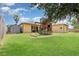 Large backyard featuring a playset and lush green grass, perfect for outdoor activities at 2739 Village Pine Ter, Orlando, FL 32833