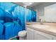 Bright bathroom featuring a vanity with sink, toilet, mirror, and marine-themed shower curtain at 2739 Village Pine Ter, Orlando, FL 32833