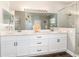 Bathroom featuring double sinks, quartz countertops, and sleek glass shower, with view to the neighborhood at 2739 Village Pine Ter, Orlando, FL 32833