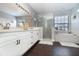 Elegant bathroom with double vanity, glass shower enclosure, and soaking tub at 2739 Village Pine Ter, Orlando, FL 32833