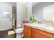 Cozy bathroom featuring a glass enclosed shower, wood vanity, and updated fixtures at 2739 Village Pine Ter, Orlando, FL 32833