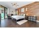Stylish bedroom features a wood-accent wall, sliding glass doors, and tile flooring at 2739 Village Pine Ter, Orlando, FL 32833