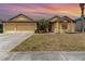 Inviting home featuring a three-car garage, well-manicured lawn, and tropical landscaping at 2739 Village Pine Ter, Orlando, FL 32833