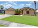 Charming single-Gathering home featuring an attached two-car garage and a well-manicured lawn at 2739 Village Pine Ter, Orlando, FL 32833
