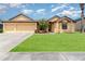 Charming single-Gathering home featuring an attached two-car garage and a well-manicured lawn at 2739 Village Pine Ter, Orlando, FL 32833
