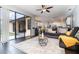 Bright living room featuring an open layout, modern decor, and sliding glass doors to outdoor living at 2739 Village Pine Ter, Orlando, FL 32833