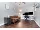 Well-lit home office with a comfortable sitting area and an adjustable standing desk setup at 2739 Village Pine Ter, Orlando, FL 32833
