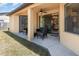 A covered patio features a ceiling fan and outdoor seating, with sliding glass doors leading inside at 2739 Village Pine Ter, Orlando, FL 32833