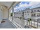 Charming balcony view of the street showcasing white townhomes and landscaped front yards on a sunny day at 312 Grand Bay Ln, Celebration, FL 34747