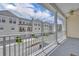Charming balcony view of the street showcasing white townhomes and landscaped front yards on a sunny day at 312 Grand Bay Ln, Celebration, FL 34747