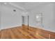 Spacious bedroom featuring hardwood floors, white trim, ceiling fan, and doorways at 312 Grand Bay Ln, Celebration, FL 34747