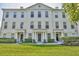 Elegant townhouse featuring a well-manicured lawn and classic architectural details at 312 Grand Bay Ln, Celebration, FL 34747