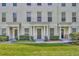 Inviting townhouse facade with lush landscaping, a covered entryway, and classic design at 312 Grand Bay Ln, Celebration, FL 34747