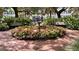 Charming brick courtyard featuring a tiered fountain surrounded by lush greenery and inviting benches at 312 Grand Bay Ln, Celebration, FL 34747