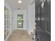 Bright foyer with tiled flooring, a glass-paneled door, and freshly painted white walls at 312 Grand Bay Ln, Celebration, FL 34747