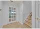 Bright foyer with tile flooring, staircase, and glass door letting in natural light at 312 Grand Bay Ln, Celebration, FL 34747