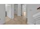 Clean hallway with tile flooring leading to a utility room and bathroom at 312 Grand Bay Ln, Celebration, FL 34747