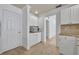 Efficient kitchen with white cabinets and stainless steel appliances, plus easy access to the pantry and living area at 312 Grand Bay Ln, Celebration, FL 34747