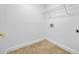 Clean and functional laundry room area with tile floor and upper shelving for storage at 312 Grand Bay Ln, Celebration, FL 34747