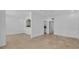 Spacious living room with white walls, tile flooring, and a view of the kitchen through an archway at 312 Grand Bay Ln, Celebration, FL 34747