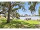 Enjoy the scenic view, shaded by trees, with a glimpse of the lake and city skyline, with bench and dock at 320 Lakeview St # 222, Orlando, FL 32804