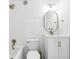 Bright bathroom with white tile, modern fixtures, and an oval mirror at 320 Lakeview St # 222, Orlando, FL 32804