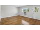 Bright, neutral bedroom featuring hardwood floors, a window with natural light, and ample space for customization at 320 Lakeview St # 222, Orlando, FL 32804