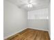 Simple bedroom featuring hardwood floors, white walls, a ceiling fan, and a window at 320 Lakeview St # 222, Orlando, FL 32804