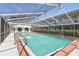 Community pool featuring a covered enclosure, lounge chairs, and a well-maintained pool deck at 320 Lakeview St # 222, Orlando, FL 32804
