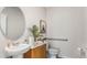 Modern powder room features a pedestal sink, unique decorative mirror, and stylish fixtures at 3206 Partington Blvd, Davenport, FL 33837