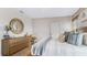 Comfortable bedroom with dresser, round mirror and cozy chair at 3206 Partington Blvd, Davenport, FL 33837