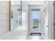 Bright entryway featuring a modern door with glass panels, light tile floors, and shiplap accent wall at 3206 Partington Blvd, Davenport, FL 33837