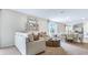 Cozy living room with shiplap accent wall, comfortable seating, and adjacent dining area for entertaining guests at 3206 Partington Blvd, Davenport, FL 33837
