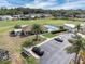 Aerial view of a community featuring a pool, a golf course, surrounding houses, and a parking lot at 367 Par Pines Blvd, Davenport, FL 33837