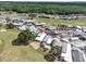 An aerial view shows a vibrant community with manicured lawns near a golf course and mature trees at 367 Par Pines Blvd, Davenport, FL 33837