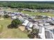 An aerial view shows a vibrant community with manicured lawns near a golf course and mature trees at 367 Par Pines Blvd, Davenport, FL 33837