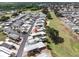 An aerial view shows a vibrant community with manicured lawns near a golf course and mature trees at 367 Par Pines Blvd, Davenport, FL 33837