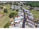 An aerial view shows a vibrant community with manicured lawns near a golf course and serene ponds at 367 Par Pines Blvd, Davenport, FL 33837