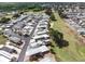 An aerial view shows a vibrant community with manicured lawns near a golf course and mature trees at 367 Par Pines Blvd, Davenport, FL 33837