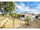 Scenic backyard with pebble ground cover, mature palms, and a well-manicured lawn at 367 Par Pines Blvd, Davenport, FL 33837