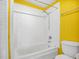 Clean bathroom featuring a shower and tub combination with white tile and updated fixtures at 367 Par Pines Blvd, Davenport, FL 33837