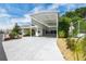Exterior view of home with a large carport and landscaped yard in a well-maintained community at 367 Par Pines Blvd, Davenport, FL 33837