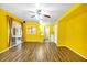 Bright living room featuring wood floors, ceiling fan, and sliding glass doors to the screened-in porch at 367 Par Pines Blvd, Davenport, FL 33837
