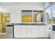 Wet bar featuring white cabinets, tile countertops, and a compact refrigerator at 367 Par Pines Blvd, Davenport, FL 33837