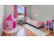 Charming pink themed bedroom with a princess tent and a cozy bed by the window at 4544 Point Look Out Rd, Orlando, FL 32808