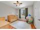 Cozy bedroom with a crib and play tent near the window at 4544 Point Look Out Rd, Orlando, FL 32808